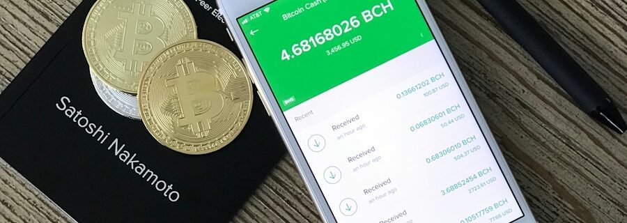 silver iPhone 6 beside two coins