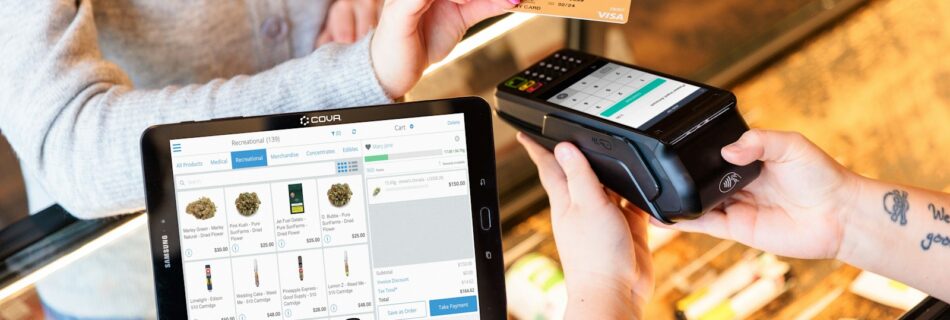 a woman is paying a card from a machine