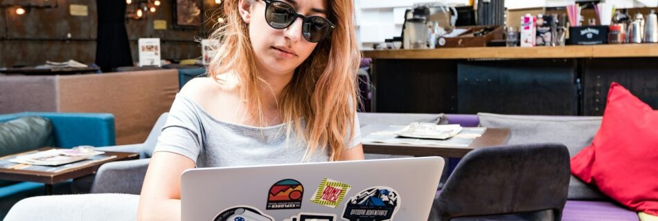 a woman sitting at a table with a laptop
